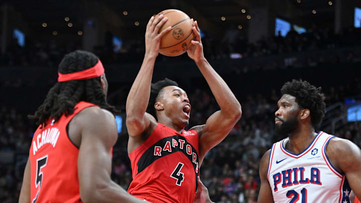 Oct 28, 2023; Toronto, Ontario, CAN; Toronto Raptors forward Scottie Barnes (4) drives to the basket past Philadelphia 76ers Joel Embiid (21) in the second half at Scotiabank Arena. Mandatory Credit: Dan Hamilton-USA TODAY Sports