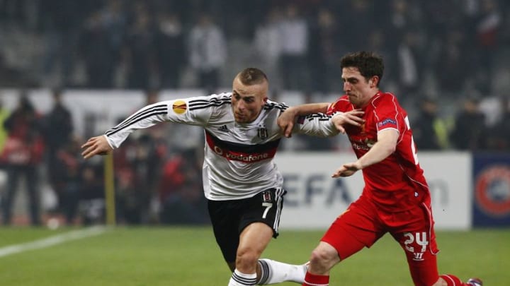 ISTANBUL, TURKEY - FEBRUARY 26: Gokhan Tore (L) of Besiktas in action against Joe Allen (R) of Liverpool during the UEFA Europa League Round of 32 match between Besiktas and Liverpool at Ataturk Olympiad Stadium in Istanbul, Turkey on February 26, 2015. (Photo by Bulent Doruk/Anadolu Agency/Getty Images)