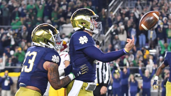 Oct 23, 2021; South Bend, Indiana, USA; Notre Dame Fighting Irish quarterback Tyler Buchner (12) and running back Kyren Williams (23) celebrate after a touchdown run by Buchner in the fourth quarter against the USC Trojans at Notre Dame Stadium. Mandatory Credit: Matt Cashore-USA TODAY Sports