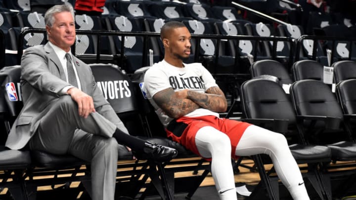 General Manager Neil Olshey of the Portland Trail Blazers sits with Damian Lillard #0 during warmups before Game Six of the Western Conference Semifinals (Photo by Steve Dykes/Getty Images)