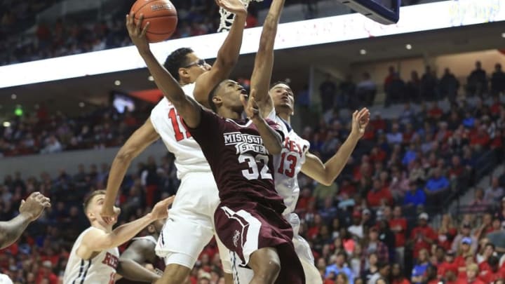 Mar 2, 2016; Oxford, MS, USA; Mississippi State Bulldogs guard Craig Sword (32) shoots the ball against Mississippi Rebels forward Sebastian Saiz (11) and Mississippi Rebels forward Anthony Perez (13) during the second half at The Pavilion at Ole Miss. Mississippi Rebels defeat Mississippi State Bulldogs 86-78. Mandatory Credit: Spruce Derden-USA TODAY Sports