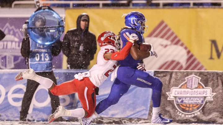BOISE, ID – DECEMBER 1: Running back Alexander Mattison #22 of the Boise State Broncos drags defensive back Juju Hughes #23 of the Fresno State Bulldogs enroute to a touchdown during second half action in the Mountain West Championship on December 1, 2018 at Albertsons Stadium in Boise, Idaho. Fresno State won the game 19-16 in overtime. (Photo by Loren Orr/Getty Images)
