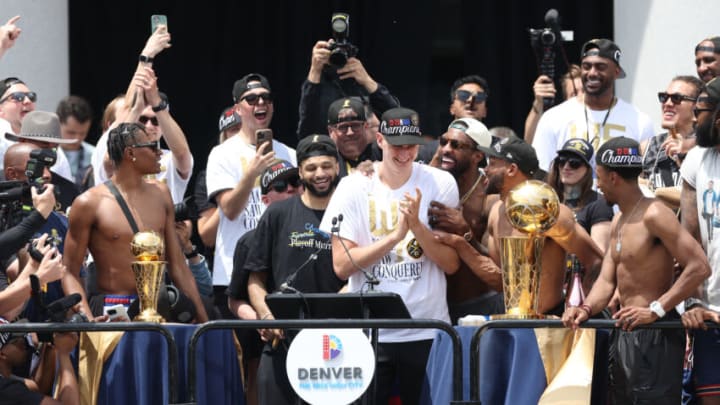 DENVER, COLORADO - JUNE 15: Jamal Murray #27, Nikola Jokic #15 and Jeff Green #32 react on state during the Denver Nuggets victory parade and rally after winning the 2023 NBA Championship at Civic Center Park on June 15, 2023 in Denver, Colorado. NOTE TO USER: User expressly acknowledges and agrees that, by downloading and or using this photograph, User is consenting to the terms and conditions of the Getty Images License Agreement. (Photo by Matthew Stockman/Getty Images)