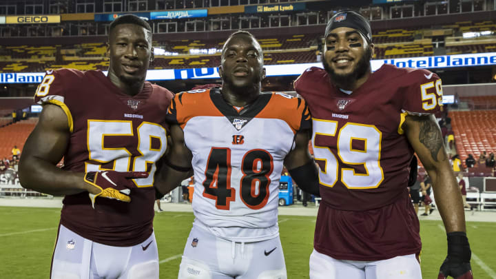 LANDOVER, MD – AUGUST 15: Cassanova McKinzy #58 and Darrell Williams #59 of the Washington Redskins stand with Deshaun Davis #48 of the Cincinnati Bengals for a photo after a preseason game at FedExField on August 15, 2019 in Landover, Maryland. (Photo by Scott Taetsch/Getty Images)