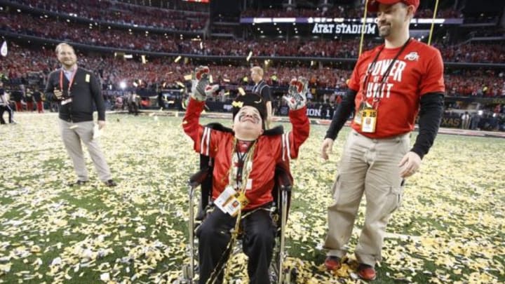Jan 12, 2015; Arlington, TX, USA; Ohio State Buckeyes fan Jacob Jarvis celebrates on the field after the Buckeyes beat the Oregon Ducks in the 2015 CFP National Championship Game at AT&T Stadium. Mandatory Credit: Tim Heitman-USA TODAY Sports