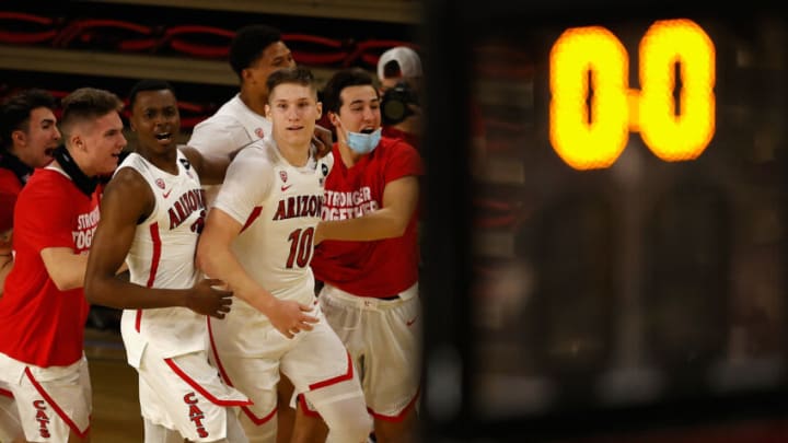 TEMPE, ARIZONA - JANUARY 21: Azuolas Tubelis #10 of the Arizona Wildcats celebrates with teammates after scoring against the Arizona State Sun Devils during the final seconds to win the NCAAB game at Desert Financial Arena on January 21, 2021 in Tempe, Arizona. The Wildcats defeated the Sun Devils 84-82. (Photo by Christian Petersen/Getty Images)