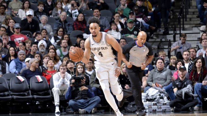 SAN ANTONIO, TX - DECEMBER 31: Derrick White #4 of the San Antonio Spurs handles the ball against the Boston Celtics on December 31, 2018 at the AT&T Center in San Antonio, Texas. NOTE TO USER: User expressly acknowledges and agrees that, by downloading and or using this photograph, user is consenting to the terms and conditions of the Getty Images License Agreement. Mandatory Copyright Notice: Copyright 2018 NBAE (Photos by Mark Sobhani/NBAE via Getty Images)
