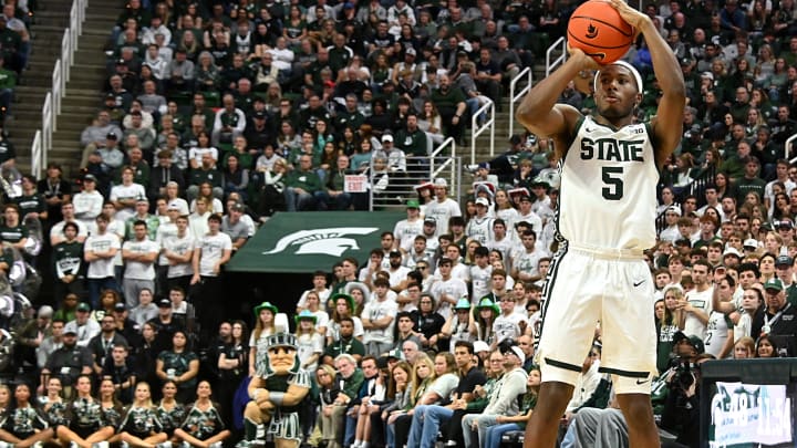 Nov 17, 2023; East Lansing, Michigan, USA; Michigan State Spartans guard Tre Holloman (5) shoots a three-point shot against the Butler Bulldogs during the second half at Jack Breslin Student Events Center. Mandatory Credit: Dale Young-USA TODAY Sports