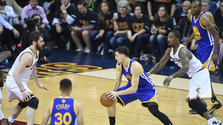 Jun 16, 2016; Cleveland, OH, USA; Golden State Warriors guard Klay Thompson (11) dribbles the ball in front of Cleveland Cavaliers forward Kevin Love (0) and guard J.R. Smith (5) during the first quarter in game six of the NBA Finals at Quicken Loans Arena. Mandatory Credit: Ken Blaze-USA TODAY Sports