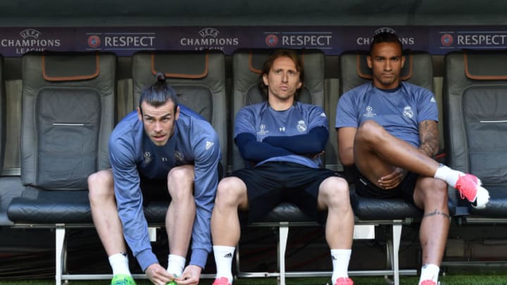 (L-R) Real Madrid's Welsh striker Gareth Bale, Real Madrid's Croatian Luka Modric and Brazilian defender Danilo wait at the bench prior to a training session on the eve of the UEFA Champions League quarter-final football match between FC Bayern Munich and Real Madrid in Munich, southern Germany, on April 11, 2017. / AFP PHOTO / Christof STACHE (Photo credit should read CHRISTOF STACHE/AFP/Getty Images)