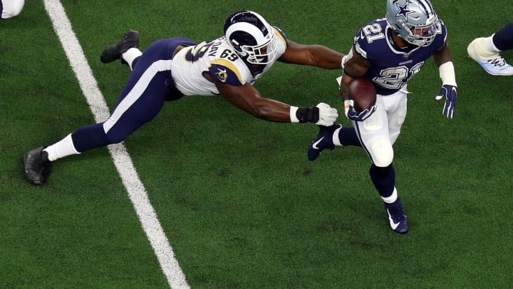 ARLINGTON, TEXAS – DECEMBER 15: Sebastian Joseph-Day #69 of the Los Angeles Rams tries to stop the run by Ezekiel Elliott #21 of the Dallas Cowboys in the first quarter at AT&T Stadium on December 15, 2019 in Arlington, Texas. (Photo by Richard Rodriguez/Getty Images)