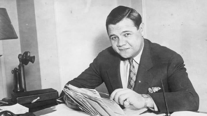 circa 1935: Babe Ruth (George Herman Ruth, 1895 – 1948) American professional baseball player signs a new two year contract with the ‘New York Yankees’. (Photo by General Photographic Agency/Getty Images)
