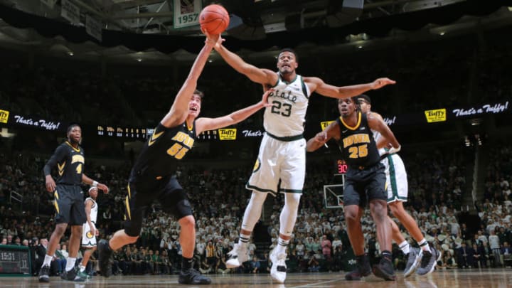 EAST LANSING, MI - DECEMBER 03: Luka Garza #55 of the Iowa Hawkeyes fight for a loose ball against Xavier Tilman #23 of the Michigan State Spartans in the second half at Breslin Center on December 3, 2018 in East Lansing, Michigan. (Photo by Rey Del Rio/Getty Images)
