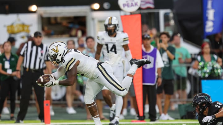 HONOLULU, HI – AUGUST 27: Ray Davis #2 of the Vanderbilt Commodores finds his way into the end zone to score a touchdown after being tripped out by Leonard Lee #26 of the Hawaii Rainbow Warriors during the second half of an NCAA football game at the Clarance T.C. Ching Athletic Complex on August 27, 2022 in Honolulu, Hawaii. (Photo by Darryl Oumi/Getty Images)