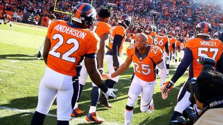 Jan 12, 2014; Denver, CO, USA; Denver Broncos cornerback Chris Harris (25) greets teammates prior to the game against the San Diego Chargers during the 2013 AFC divisional playoff football game at Sports Authority Field at Mile High. Denver defeated San Diego 24-17. Mandatory Credit: Mark J. Rebilas-USA TODAY Sports