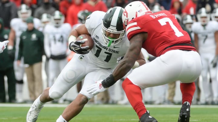 LINCOLN, NE – NOVEMBER 17: Running back Connor Heyward #11 of the Michigan State Spartans drives for additional yards against linebacker Mohamed Barry #7 of the Nebraska Cornhuskers at Memorial Stadium on November 17, 2018 in Lincoln, Nebraska. (Photo by Steven Branscombe/Getty Images)