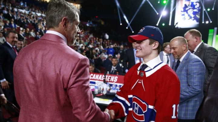 VANCOUVER, BRITISH COLUMBIA - JUNE 21: Cole Caufield, 15th overall pick of the Montreal Canadiens, shakes the hand of Marc Bergevin on the draft floor during the first round of the 2019 NHL Draft at Rogers Arena on June 21, 2019 in Vancouver, Canada. (Photo by Jeff Vinnick/NHLI via Getty Images)