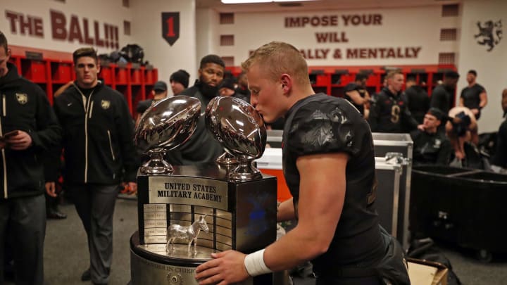 Dec 8, 2018; Philadelphia, PA, USA; Army Black Knights punter Zach Potter (17) kisses the Commander-in-Chief Trophy after Army beat Navy 17-10 to win the 119th Army-Navy game at Lincoln Financial Field. Mandatory Credit: Danny Wild-USA TODAY Sports