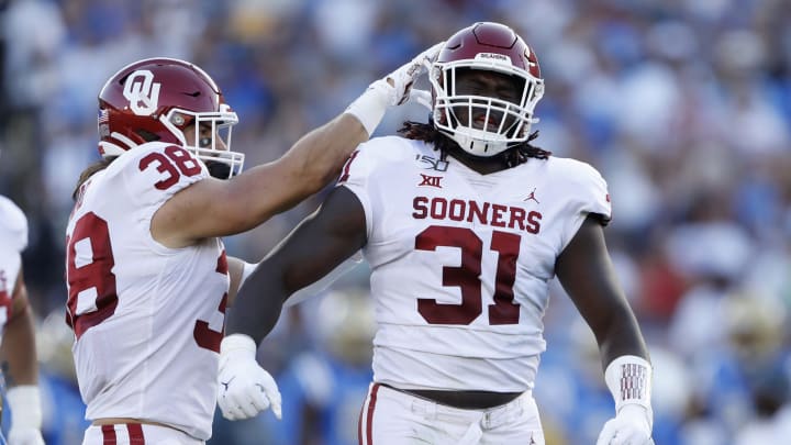 LOS ANGELES, CALIFORNIA –  Bryan Mead #38 congratulates Jalen Redmond #31 of the Oklahoma Sooners after his sack of Dorian Thompson-Robinson #1 of the UCLA Bruins.  (Photo by Sean M. Haffey/Getty Images)