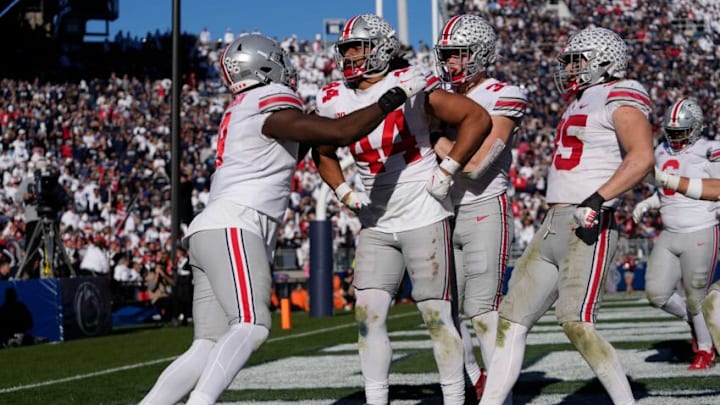 Oct 29, 2022; University Park, Pennsylvania, USA; Teammates celebrate a pick-6 touchdown by defensive end J.T. Tuimoloau (44) during the fourth quarter of the NCAA Division I football game against the Penn State Nittany Lions at Beaver Stadium. Mandatory Credit: Adam Cairns-The Columbus DispatchNcaa Football Ohio State Buckeyes At Penn State Nittany Lions Oct 29, 2022; University Park, Pennsylvania, USA; Teammates celebrate a pick-6 touchdown by defensive end J.T. Tuimoloau (44) during the fourth quarter of the NCAA Division I football game against the Penn State Nittany Lions at Beaver Stadium. Mandatory Credit: Adam Cairns-The Columbus DispatchNcaa Football Ohio State Buckeyes At Penn State Nittany Lions