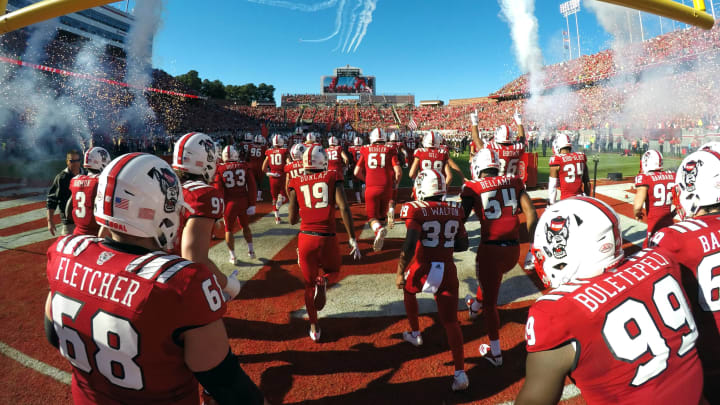 RALEIGH, NC – NOVEMBER 03: Players of the North Carolina State Wolfpack run onto the field as planes fly overhead prior to their game against the Florida State Seminoles at Carter-Finley Stadium on November 3, 2018 in Raleigh, North Carolina. (Photo by Lance King/Getty Images)