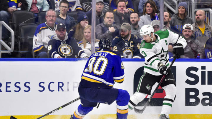 Dec 17, 2021; St. Louis, Missouri, USA; Dallas Stars defenseman John Klingberg (3) passes the puck as St. Louis Blues center Ryan O'Reilly (90) defends during the first period at Enterprise Center. Mandatory Credit: Jeff Curry-USA TODAY Sports