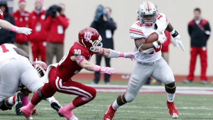 Oct 3, 2015; Bloomington, IN, USA; Ohio State Buckeyes running back Ezekiel Elliott (15) runs with the ball against Indiana Hoosiers safety Cjase Dutra (30) at Memorial Stadium. Mandatory Credit: Brian Spurlock-USA TODAY Sports