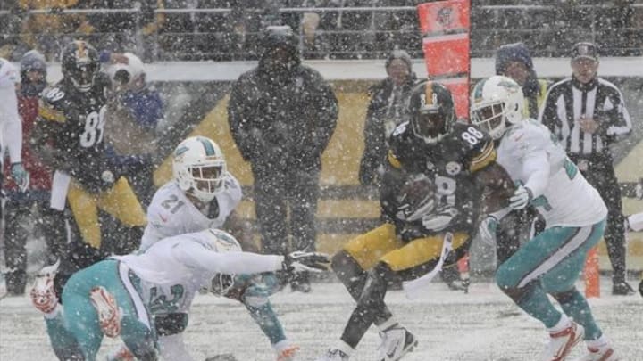 Dec 8, 2013; Pittsburgh, PA, USA; Pittsburgh Steelers wide receiver Jerricho Cotchery (89) scores a touchdown as he is hit by Miami Dolphins cornerback Dimitri Patterson (24) during the first half at Heinz Field. Mandatory Credit: Jason Bridge-USA TODAY Sports