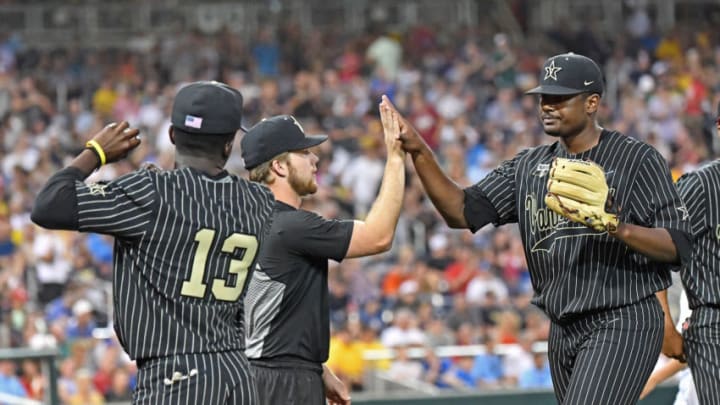 OMAHA, NE - JUNE 25: Pitcher Kumar Rocker #80 of the Vanderbilt Commodores gets a hand from his teammates, as he comes out of the game in the seventh inning against the Michigan Wolverines during game two of the College World Series Championship Series on June 25, 2019 at TD Ameritrade Park Omaha in Omaha, Nebraska. (Photo by Peter Aiken/Getty Images)