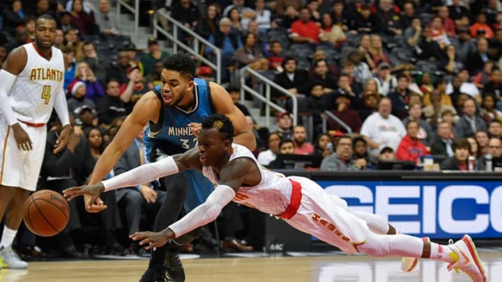 Dec 21, 2016; Atlanta, GA, USA; Minnesota Timberwolves center Karl-Anthony Towns (32) and Atlanta Hawks guard Dennis Schroder (17) go after a loose ball during the second half at Philips Arena. The Timberwolves defeated the Hawks 92-84. Mandatory Credit: Dale Zanine-USA TODAY Sports