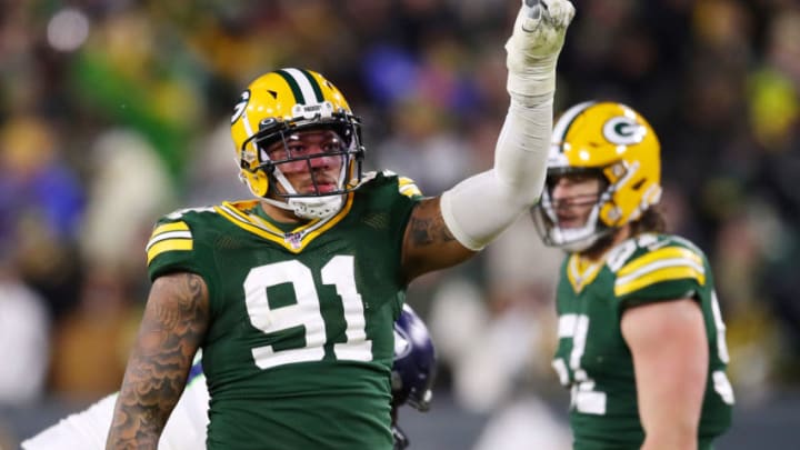 GREEN BAY, WISCONSIN - JANUARY 12: Preston Smith #91 of the Green Bay Packers celebrates after sacking Russell Wilson #3 of the Seattle Seahawks (not pictured) during the fourth quarter in the NFC Divisional Playoff game at Lambeau Field on January 12, 2020 in Green Bay, Wisconsin. (Photo by Gregory Shamus/Getty Images)