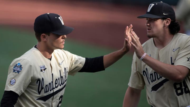 Vanderbilt pitcher Jack Leiter (22) is congratulated by teammate Patrick Reilly (88) after his first inning against NC State during game six in the NCAA Men’s College World Series at TD Ameritrade Park Monday, June 21, 2021 in Omaha, Neb.Nas Vandy Nc State 026