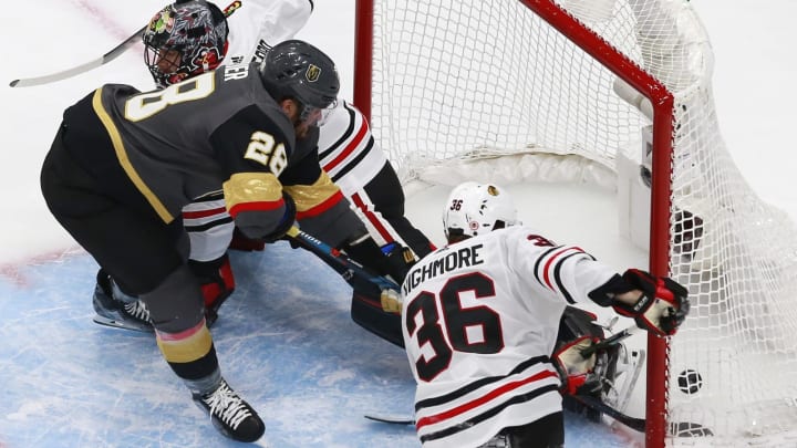 William Carrier #28 of the Vegas Golden Knights scores a goal Corey Crawford #50 and Matthew Highmore #36 of the Chicago Blackhawks during the second period in Game One of the Western Conference First Round.