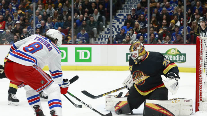 Jacob Markstrom #25 of the Vancouver Canucks makes a save against Jacob Trouba #8 of the New York Rangers