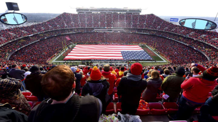 KANSAS CITY, MO - JANUARY 6: Fans stand at attention for the national anthem overlooking a 100 yard American flag prior the AFC Wild Card Playoff Game between the Kansas City Chiefs and the Tennessee Titans at Arrowhead Stadium on January 6, 2018 in Kansas City, Missouri. (Photo by Jason Hanna/Getty Images)