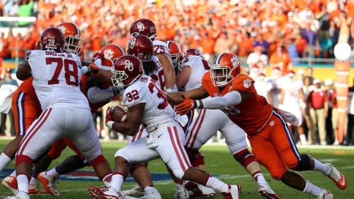 Dec 31, 2015; Miami Gardens, FL, USA; Oklahoma Sooners running back Samaje Perine (32) runs the ball against Clemson Tigers defensive end Kevin Dodd (98) during the first half of the 2015 CFP semifinal at the Orange Bowl at Sun Life Stadium. Mandatory Credit: Steve Mitchell-USA TODAY Sports