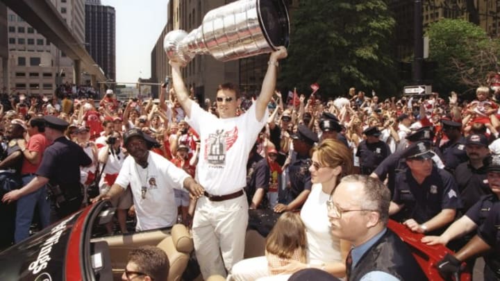 10 Jun 1997: Center Steve Yzerman of the Detroit Red Wings holds the Stanley Cup during the Stanley Cup Victory Parade in Detroit, Michigan. Mandatory Credit: Robert Laberge /Allsport