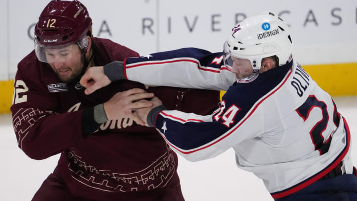 Feb 19, 2023; Tempe, Arizona, USA; Arizona Coyotes left wing Nick Ritchie (12) and Columbus Blue Jackets right wing Mathieu Olivier (24) fight during the third period at Mullett Arena. Mandatory Credit: Joe Camporeale-USA TODAY Sports
