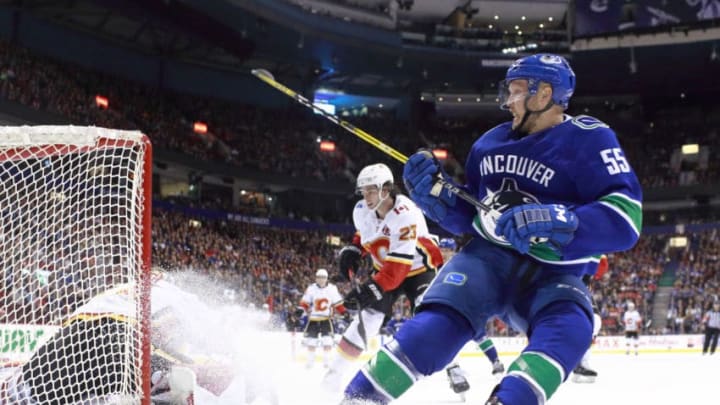 VANCOUVER, BC - MARCH 23: Mike Smith #41 of the Calgary Flames makes a save off the shot of Alex Biega #55 of the Vancouver Canucks during their NHL game at Rogers Arena March 23, 2019 in Vancouver, British Columbia, Canada. (Photo by Jeff Vinnick/NHLI via Getty Images)"n