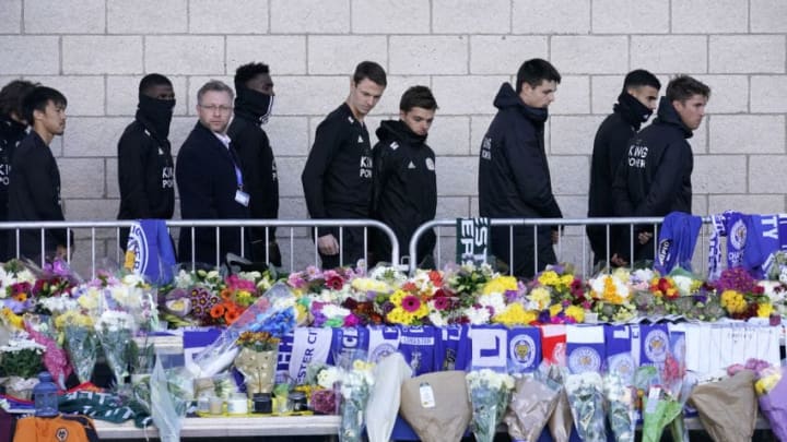LEICESTER, ENGLAND - OCTOBER 29: Leicester City Football Club players pay their respects at the sea of tributes to the victims of the helicopter crash at Leicester City Football Club's King Power Stadium on October 28, 2018 in Leicester, England. The owner of Leicester City Football Club, Club owner Vichai Srivaddhanaprabha, was among the five people who died in the helicopter crash on Saturday evening after the club's game against West Ham. (Photo by Christopher Furlong/Getty Images)