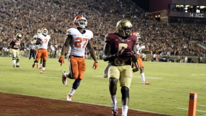 Sep 20, 2014; Tallahassee, FL, USA; Florida State Seminoles running back Karlos Williams (9) scores the game winning overtime touchdown against the Clemson Tigers for their 23-17 overtime win at Doak Campbell Stadium. Mandatory Credit: John David Mercer-USA TODAY Sports Sep 20, 2014; Tallahassee, FL, USA; Florida State Seminoles running back Karlos Williams (9) scores the game winning overtime touchdown against the Clemson Tigers for their 23-17 overtime win at Doak Campbell Stadium. Mandatory Credit: John David Mercer-USA TODAY Sports