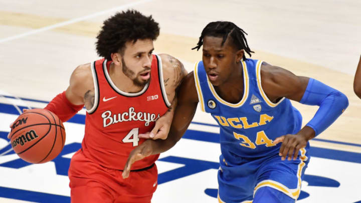 Dec 19, 2020; Cleveland, Ohio, USA; Ohio State Buckeyes guard Duane Washington Jr. (4) drives to the basket against UCLA Bruins guard David Singleton (34) during the first half at Rocket Mortgage FieldHouse. Mandatory Credit: Ken Blaze-USA TODAY Sports