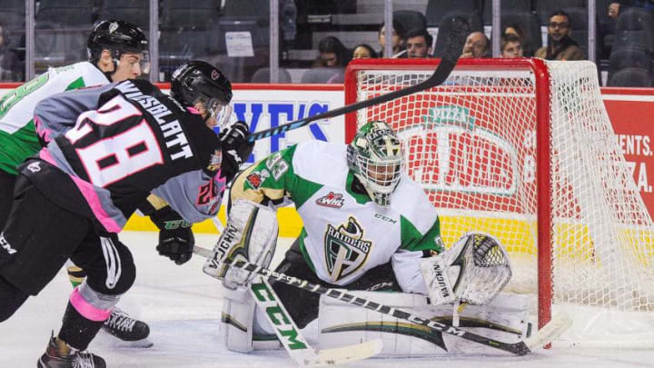 Orca Wiesblatt #28 of the Calgary Hitmen takes a shot on Ian Scott #33 of the Prince Albert Raiders during a WHL game. (Photo by Derek Leung/Getty Images)