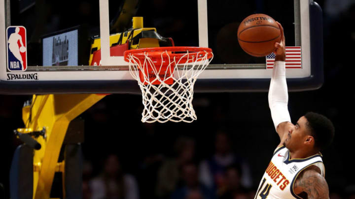 DENVER, COLORADO - NOVEMBER 05: Gary Harris #14 of the Denver Nuggets dunks against Meyers Leonard #0 of the Miami Heat in the first quarter at the Pepsi Center on November 05, 2019 in Denver, Colorado. NOTE TO USER: User expressly acknowledges and agrees that, by downloading and or using this photograph, User is consenting to the terms and conditions of the Getty Images License Agreement. (Photo by Matthew Stockman/Getty Images)