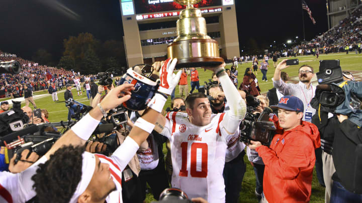 Nov 28, 2015; Starkville, MS, USA; Mississippi Rebels quarterback Chad Kelly (10) celebrates with the Egg Bowl trophy after the game against the Mississippi State Bulldogs at Davis Wade Stadium. Mississippi won 38-27. Mandatory Credit: Matt Bush-USA TODAY Sports