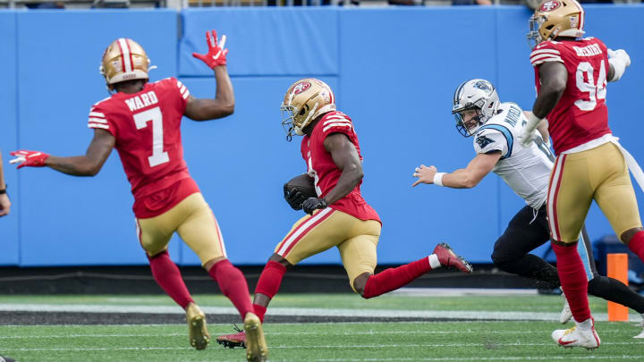 Oct 9, 2022; Charlotte, North Carolina, USA; San Francisco 49ers cornerback Emmanuel Moseley (4) runs an interception in for a touchdown against the Carolina Panthers during the second quarter at Bank of America Stadium. Mandatory Credit: Jim Dedmon-USA TODAY Sports