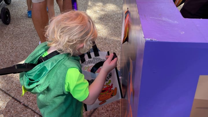 A young boy looks into his empty bag at SeaWorld’s annual Halloween trick or treat event