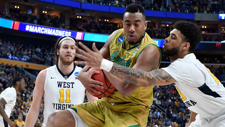 Mar 18, 2017; Buffalo, NY, USA; Notre Dame Fighting Irish forward Bonzie Colson (35) grabs a rebound against West Virginia Mountaineers forward Esa Ahmad (right) as forward Nathan Adrian (11) looks on in the first half during the second round of the 2017 NCAA Tournament at KeyBank Center. Mandatory Credit: Mark Konezny-USA TODAY Sports