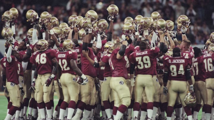Players for the Florida State Seminoles raise their helmets in celebration after winning the NCAA Nokia Sugar Bowl Championship Series (BCS) National Championship Game against the Virginia Tech Hokies on 4th January 2000 at the Louisiana Superdome, New Orleans, Louisiana, United States. The Florida State Seminoles won the game 46 - 29. (Photo by Matthew Stockman/Getty Images)