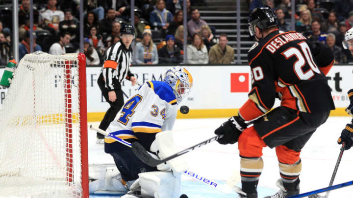 ANAHEIM, CALIFORNIA - MARCH 11: Jake Allen #34 of the St. Louis Blues blocks a shot on goal as Nicolas Deslauriers #20 of the Anaheim Ducks rushes the puck during the third period of a game at Honda Center on March 11, 2020 in Anaheim, California. (Photo by Sean M. Haffey/Getty Images)